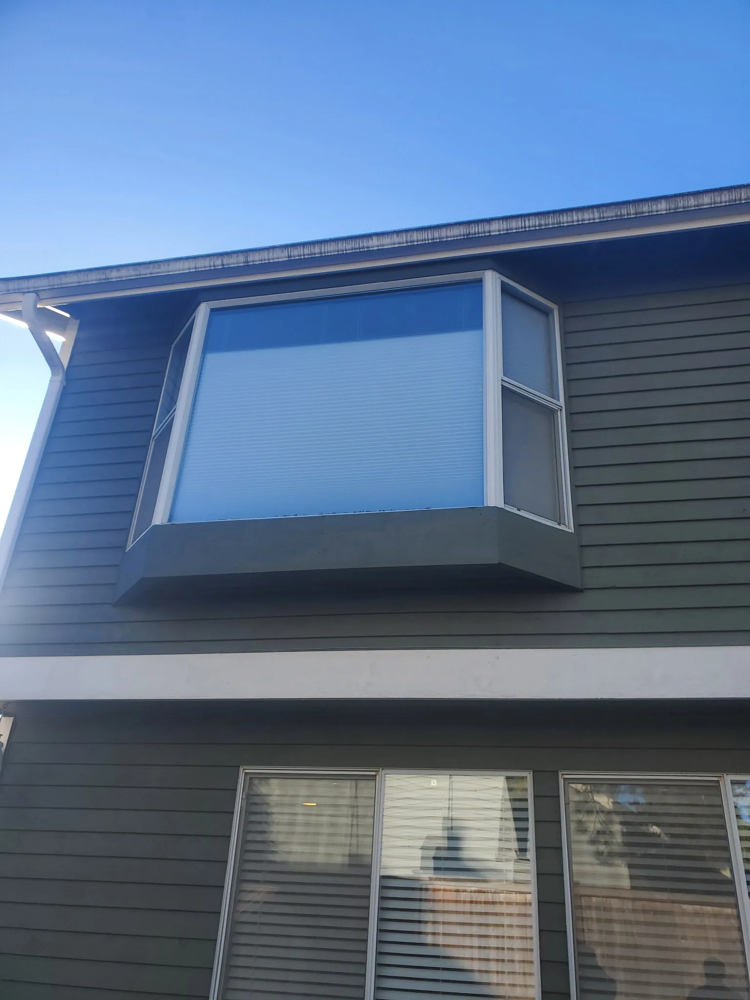 Exterior view of a finished residential bay window glass replacement