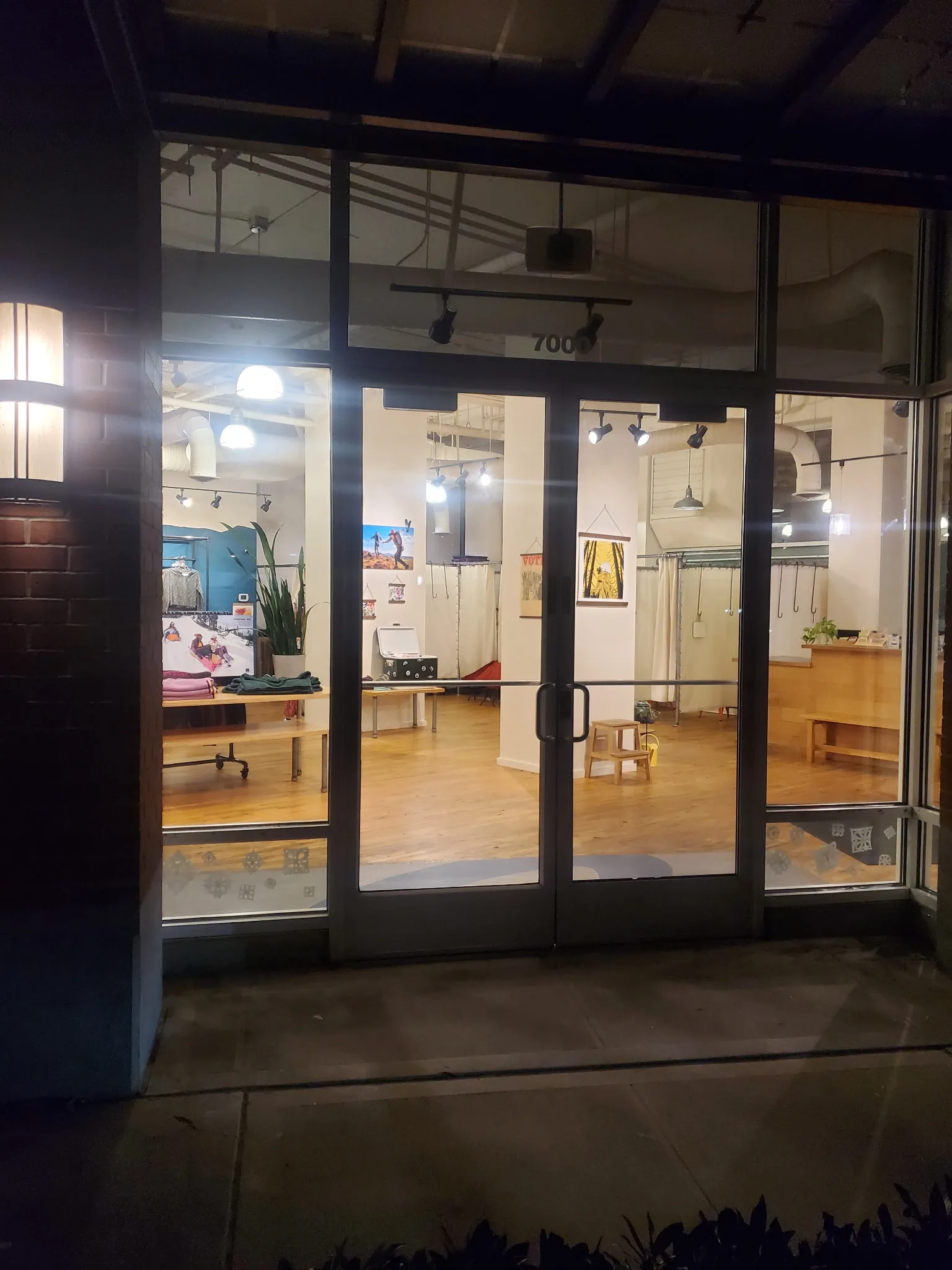 Restored commercial storefront entry with finished black-frame glass doors